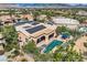 Aerial shot showcasing pool, outdoor seating, solar panels and lush landscaping at 4980 Pensier St, Las Vegas, NV 89135