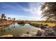Scenic water view on the golf course community with lush landscaping and blue skies at 4980 Pensier St, Las Vegas, NV 89135