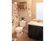 Well-lit bathroom with dark wood cabinet, granite counters, a shower and decorative storage at 5541 Alvarez St, North Las Vegas, NV 89031