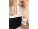 Well-lit bathroom features granite countertops and a vanity with black cabinets at 5541 Alvarez St, North Las Vegas, NV 89031