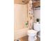 This bathroom features a shower-tub combo, a toilet, and a mounted storage shelf at 5541 Alvarez St, North Las Vegas, NV 89031