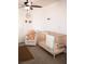 Charming Bedroom includes crib, plush chair, ceiling fan and animal themed wall decorations at 5541 Alvarez St, North Las Vegas, NV 89031