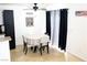 Bright dining area features tiled floors, a ceiling fan, and windows covered by curtains at 5541 Alvarez St, North Las Vegas, NV 89031