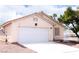 Cozy single-story home featuring a two-car garage and well-maintained landscaping under a bright sky at 5541 Alvarez St, North Las Vegas, NV 89031
