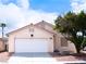 Charming single-story home featuring a two-car garage and desert landscaping under a sunny sky at 5541 Alvarez St, North Las Vegas, NV 89031