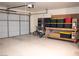Well-lit garage with door, ample storage space, and a clean concrete floor at 5541 Alvarez St, North Las Vegas, NV 89031