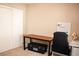 Small home office setup with desk, office chair, and minimalist decor on carpeted floor at 5541 Alvarez St, North Las Vegas, NV 89031
