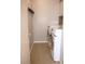 Efficient laundry room featuring modern white appliances and a tile floor at 5541 Alvarez St, North Las Vegas, NV 89031