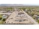 Expansive construction site featuring graded dirt and landscaping, set against a backdrop of mountains and lush greenery at 5885 St Ebbes Ct, Las Vegas, NV 89131