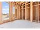 Unfinished bedroom 2 featuring wood framing and a window view at 5885 St Ebbes Ct, Las Vegas, NV 89131