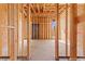 Bedroom 3 displays unfinished wood framing and a concrete slab, providing a blank canvas to personalize your space at 5885 St Ebbes Ct, Las Vegas, NV 89131