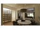 Bright dining room features an adjacent wine cellar, pendant lighting and marble table at 5885 St Ebbes Ct, Las Vegas, NV 89131