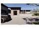 Front exterior showcasing modern design, desert landscaping, and a paved driveway with a parked SUV at 5885 St Ebbes Ct, Las Vegas, NV 89131