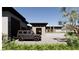 Beautiful modern home with desert landscaping, a paved driveway, and a stylish black SUV parked at 5885 St Ebbes Ct, Las Vegas, NV 89131