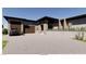 Contemporary home featuring a desert landscape, modern architecture, and a large paved driveway at 5885 St Ebbes Ct, Las Vegas, NV 89131