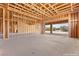 Spacious unfinished game room with wood framing and a garage door at 5885 St Ebbes Ct, Las Vegas, NV 89131