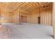 Garage features unfinished wood framing, and a concrete floor ready for vehicles and storage at 5885 St Ebbes Ct, Las Vegas, NV 89131