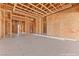 During construction, the unfinished living room features wooden beams that provides the buyer with an open space for designing at 5885 St Ebbes Ct, Las Vegas, NV 89131