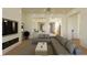 Spacious living room features a modern fireplace, hardwood floors, and a gray L-shaped couch at 5885 St Ebbes Ct, Las Vegas, NV 89131