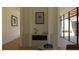 This living room is bright with natural light and features a fireplace as the focal point at 5885 St Ebbes Ct, Las Vegas, NV 89131