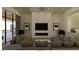 Spacious living room features a modern fireplace, hardwood floors, and a gray sectional couch at 5885 St Ebbes Ct, Las Vegas, NV 89131