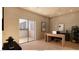 This home office features a modern desk and a door leading to an outside patio at 5885 St Ebbes Ct, Las Vegas, NV 89131