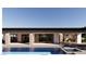 Back of the house, featuring a covered patio, backyard pool, and seamless glass windows at 5885 St Ebbes Ct, Las Vegas, NV 89131