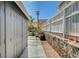 Cozy backyard featuring a pergola with seating, a stone wall, and a storage shed, perfect for outdoor entertaining at 604 I, Boulder City, NV 89005