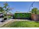 Backyard featuring a covered patio, lush lawn, mature trees, and ambient string lights at 604 I, Boulder City, NV 89005
