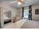 Well-lit bedroom featuring a decorative mirror, ceiling fan, and floral patterned curtains at 604 I, Boulder City, NV 89005