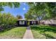 Charming single-story home with a well-manicured lawn and mature trees at 604 I, Boulder City, NV 89005