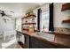Charming kitchen area featuring open shelving, a modern sink, and black cabinets at 604 I, Boulder City, NV 89005