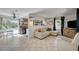 Bright living room featuring tile floors, a comfortable sofa, and a view of the backyard at 604 I, Boulder City, NV 89005