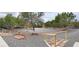 Open backyard featuring gravel ground cover, mature trees, and stepping stones at 6460 Wagon Wheel Ct, Pahrump, NV 89061