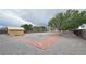 Large backyard featuring gravel ground cover, trees, a shed and a brick trimmed walkway at 6460 Wagon Wheel Ct, Pahrump, NV 89061