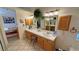 Bathroom featuring dual sinks, natural wood cabinetry and a decorative tile countertop at 6460 Wagon Wheel Ct, Pahrump, NV 89061
