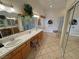 Well-lit bathroom features a dual sink vanity, soaking tub, and glass-enclosed shower at 6460 Wagon Wheel Ct, Pahrump, NV 89061