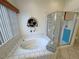 Bright bathroom with a large soaking tub and separate glass enclosed shower at 6460 Wagon Wheel Ct, Pahrump, NV 89061