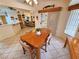 Open dining area with a wooden table and chairs adjacent to the kitchen and living spaces at 6460 Wagon Wheel Ct, Pahrump, NV 89061