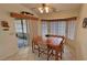 Sunlit dining area showcases a wooden dining table set with views of the outdoor area at 6460 Wagon Wheel Ct, Pahrump, NV 89061