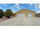 Exterior view of home featuring a spacious two-car garage and ample driveway space at 6460 Wagon Wheel Ct, Pahrump, NV 89061