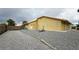 Exterior view of the home with a gravel yard and a wooden fence surrounding the property at 6460 Wagon Wheel Ct, Pahrump, NV 89061