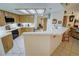 Well-lit kitchen features tile countertops, matching cabinets, and modern appliances at 6460 Wagon Wheel Ct, Pahrump, NV 89061