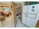 Well-organized pantry and adjacent refrigerator provide ample storage space at 6460 Wagon Wheel Ct, Pahrump, NV 89061
