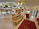 Open-concept living room with tile flooring, neutral tones, and seamless flow to dining and kitchen at 6460 Wagon Wheel Ct, Pahrump, NV 89061