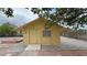 Exterior view of the shed with a window and double doors, surrounded by gravel and a fence at 6460 Wagon Wheel Ct, Pahrump, NV 89061
