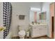 Bathroom featuring a shower-tub combo with a vanity, mirror, and ample lighting at 6480 Annie Oakley Dr # 314, Las Vegas, NV 89120