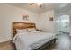 Comfortable bedroom with a wood headboard, wood-look flooring, and a ceiling fan at 6480 Annie Oakley Dr # 314, Las Vegas, NV 89120