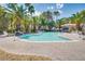 Inviting community pool surrounded by lush landscaping, lounge chairs, and palm trees at 6480 Annie Oakley Dr # 314, Las Vegas, NV 89120