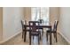 Well-lit condo dining room featuring a wood table with seating for four, complemented by modern wood-look floors at 6480 Annie Oakley Dr # 314, Las Vegas, NV 89120